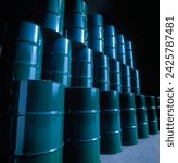 Oil barrels stacked. Green color tanks piled in depot against black background. Dark warehouse atmosphere