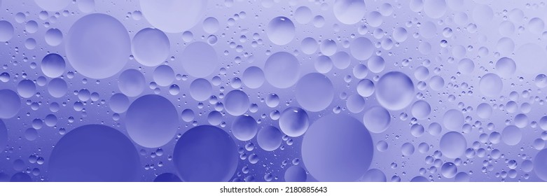 oil with bubbles on Violet background. Abstract space purple violet background. Soft selective focus. macro of oil drops on water surface. copy space. air bubbles in water. Trendy Color of Year 2022