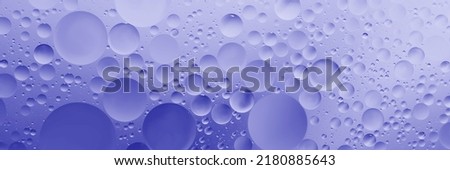 oil with bubbles on Violet background. Abstract space purple violet background. Soft selective focus. macro of oil drops on water surface. copy space. air bubbles in water. Trendy Color of Year 2022