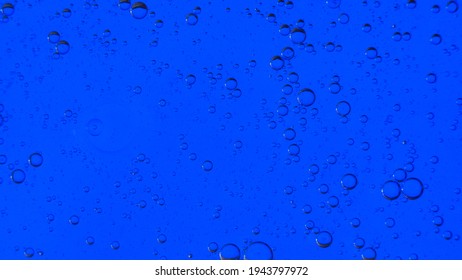 Oil Bubbles On The Water Surface In Motion, On A Blue Background, Macro, Splash Screen, Template, Copy Space