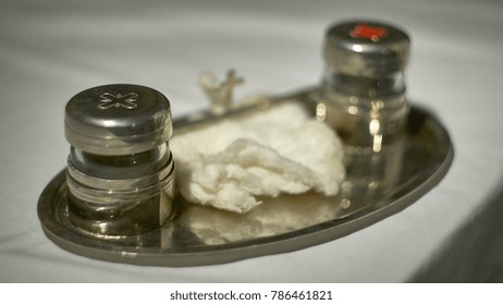 The Oil Of The Catechumens And The Chrism In Their Metal Containers Used During The Catholic Religious Rite Of Baptism.