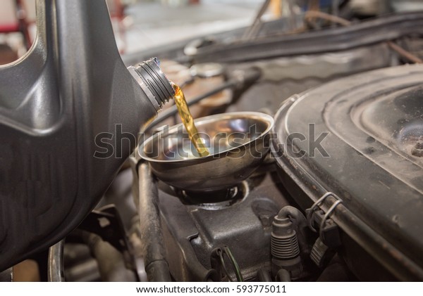 oil change, pouring oil
to car engine