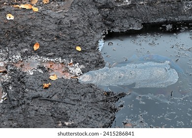 Oil contamination of the soil surface near oil wells. Environmental disaster.