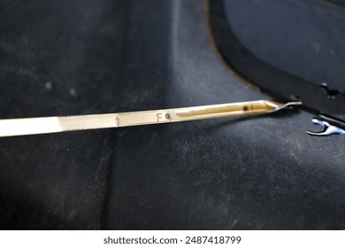 Oil dipstick for checking the oil level in the engine.