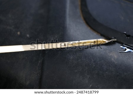 Oil dipstick for checking the oil level in the engine.