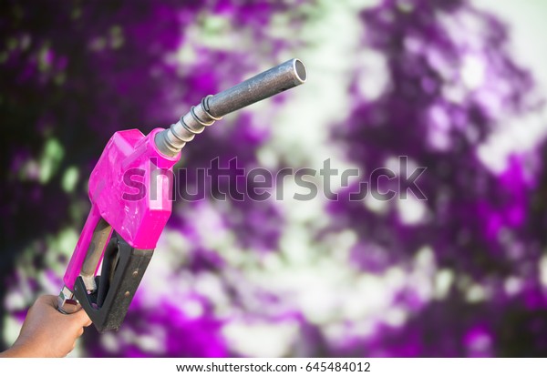 Oil dispenser Technology of trading and\
energy Pink using a handle on a bokeh\
background.