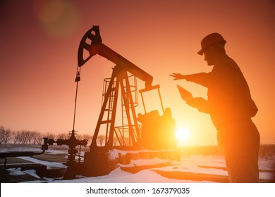 Oil Drill, Field Pump Jack Silhouette With Setting Sun And Worker. Lens Flare. See More Images And Video Refinery, Exploration, Oil And Gas Industry