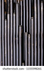 Oil Drill Pipe. Rusty Drill Pipes Were Drilled In The Well Section. Downhole Drilling Rig. Laying The Pipe On The Deck. View Of The Shell Of Drill Pipes Laid In Courtyard Of The Oil And Gas Warehouse.