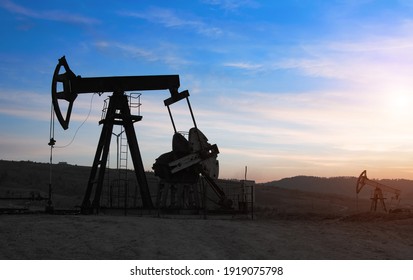 Oil Drilling Derricks At Moutain Oilfield For Fossil Fuels Output And Crude Oil Production From The Ground. Oil Drill Rig And Pump Jack.