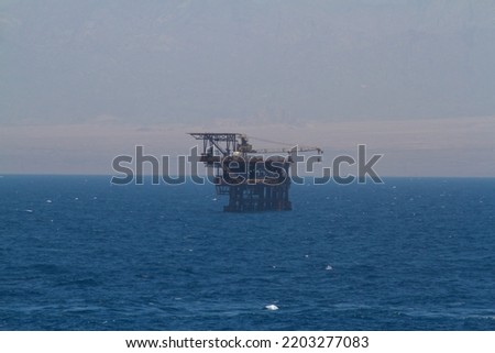 Oil drilling platform in red sea with sinai mountains in the background