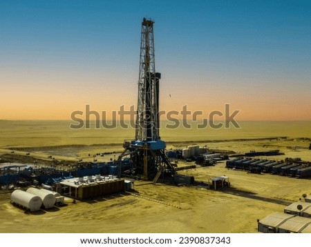 Oil drilling rig in the Arabian desert during sunset 