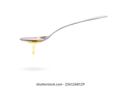 Oil drop dripping from metal spoon isolated on white background. Side view, Copy space.