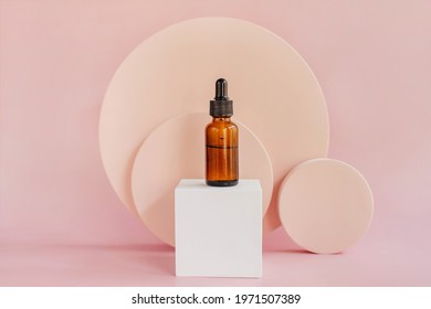 Oil dropper bottle and round podiums. Beige color background for branding and packaging presentation.  Natural skin care beauty product concept. - Shutterstock ID 1971507389
