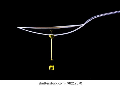 Oil drops dripping from a spoon