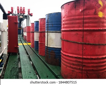 Oil drums in various colors on the vessel.