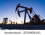 Oil field, oil drilling rig in the evening
