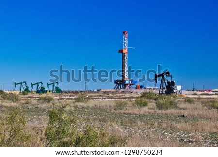 



oil field landscape with rig and pump jacks