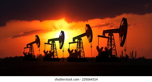 Oil Field At Sunset.