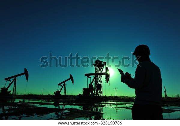 Oil field oil workers at\
work