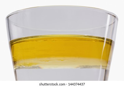 Oil Floating On Water Surface In A Glass