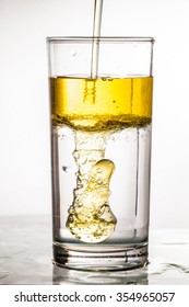 Oil Flows In Glass With Water
