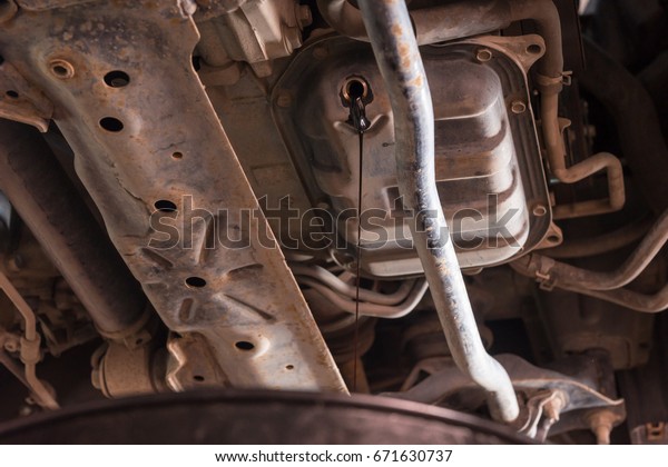 Oil\
flows out from automobile engine in a car\
workshop