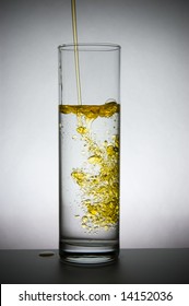 Oil Flows In A Vase With Water