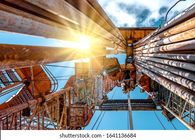 Oil And Gas Drilling Rig Onshore Dessert With Dramatic Cloudscape. Oil Drilling Rig Operation On The Oil Platform In Oil And Gas Industry