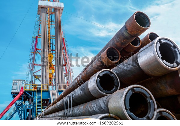 Oil and Gas Drilling Rig. Oil drilling rig operation\
on the oil platform in oil and gas industry. Top drive system of\
drilling rig.