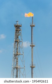 Oil and Gas Flare over Blue Sky at Daylight