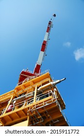 Oil And Gas Platform Standing In The Gulf Or Offshore And Operation By Technician. Crane Moving Any Cargo Or Tools Basket From Supply Boat To The Platform. Heavy Lift Was Moving By Crane Technician.