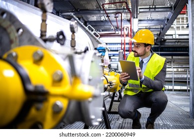 Oil And Gas Production Manager Or Supervisor With Digital Tablet Checking Natural Gas Supply And Distribution In Refinery Plant.