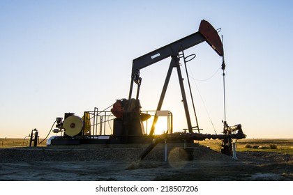 Oil And Gas. A Pump Jack In An Oilfield In Southern Alberta