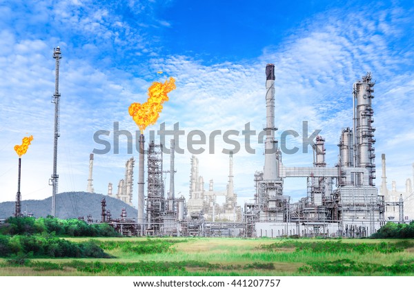 Oil and gas refinery\
plant with flare stack on blue sky background , petrochemical plant\
, Petroleum