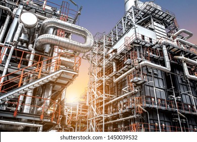 Oil and gas refinery plant form industry petroleum zone,Refinery equipment pipeline steel and oil storage tank at sunrise. -image - Shutterstock ID 1450039532