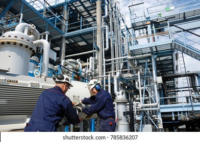 oil and gas refinery workers inside large industrial plant