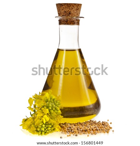 oil glass jar and mustard seeds with flower isolated on white background 