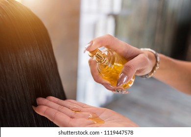 Oil hair treatment for woman. Spa, beauty salon. Hair care in modern spa salon. hairdresser woman applies a mask or oil on the hair of the client