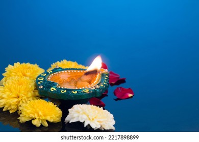 Oil lamps lit during diwali celebration with flowers - Shutterstock ID 2217898899