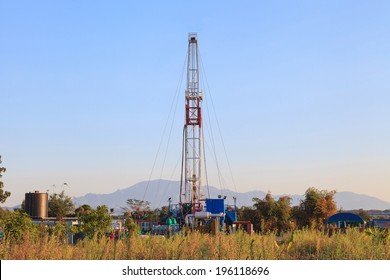 Oil Land Drilling Rig Working In The Field For Petroleum Exporation at Sunset Time