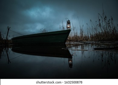 Oil lantern standing on wooden fishing boat.