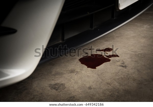 Oil leak or drop from engine of\
car on concrete floor , check and maintenance auto\
service