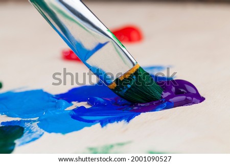 oil and other paints with brushes for creativity, the creative process of drawing by mixing different colors of paints with art brushes, art brushes and paints for painting pictures