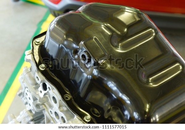 Oil pan in engine with\
plug.
