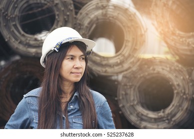 Oil Petroleum Engineering. Beautiful Woman Engineer wear White safety hard hat helmet for security equipment working at Petroleum Oil Manufacturing Industry Plant . Industry Concept.