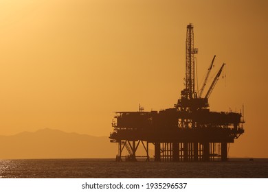 oil platform on the sea with silhouette mountains background during sunset timing from Dog Beach, California.