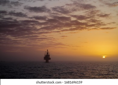 Oil Platform At Sunset In The North Sea.