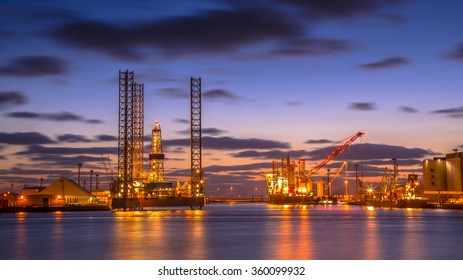 Oil Platforms being built in a manufacturing harbor under beautiful sunset