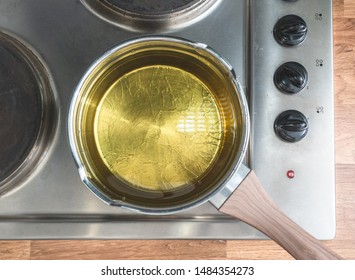 Oil In A Pot Situated Over The Stove. View From Above