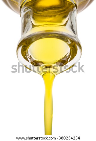 Oil pouring from a bottle. Isolated on white.